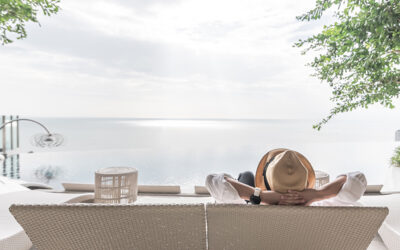 Relaxation holiday vacation of businessman take it easy happily resting on beach chair at swimming pool poolside beachfront resort hotel with sea or ocean view and summer sunny sky outdoor